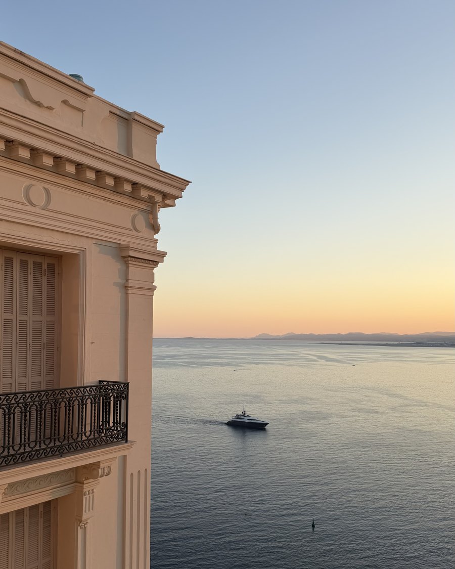 A Belle Époque façade above the bay, at dusk.