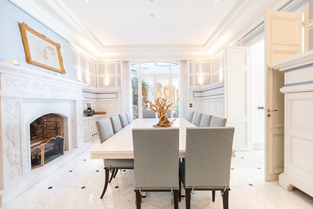 The dining room and its carved fireplace, the table laid.