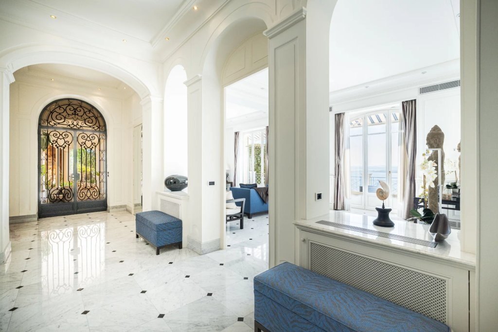 The marble hallway of the villa, the light from the window at its end.